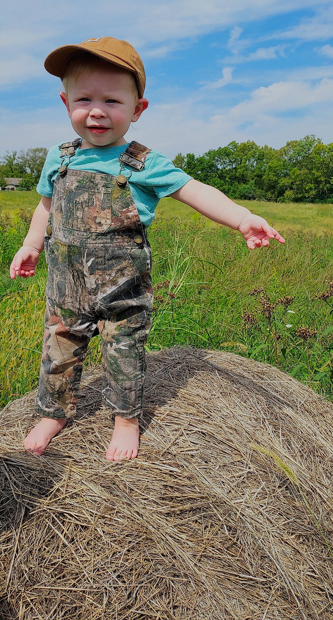 Tucker joined the competition — help win amazing prizes! agriculture, baby_toddler_clothing, cloud, finger, fun, gesture, grass, grass_family, grassland, green, happy, head, meadow, people_in_nature, person, plant, sky, sleeve, summer, t_shirt
