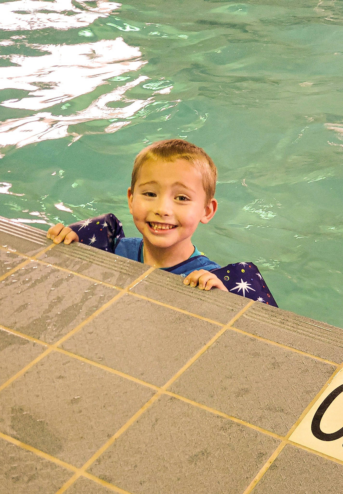 Ian is registered to the contest to win money with this photo: beauty, child, concrete, eye, facial_expression, flooring, fun, happy, head, joy, lake, leisure, ocean, pattern, person, play, recreation, road_surface, smile, toddler