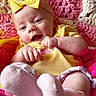 Penelope is registered to the contest to win money with this photo: baby, child, yellow_bow, headband, smile, happy, knit_blanket, pink, yellow_clothing, sock, infant, cute, portrait, closeup, hands, feet, soft_texture, colorful, playful, toddler