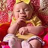 Penelope joined the competition — help win amazing prizes! baby, infant, yellow_bow, headband, yellow_clothing, pink_socks, blanket, colorful, texture, hand, face, cute, smiling, lying_down, soft, cozy, indoors, child, portrait, playful
