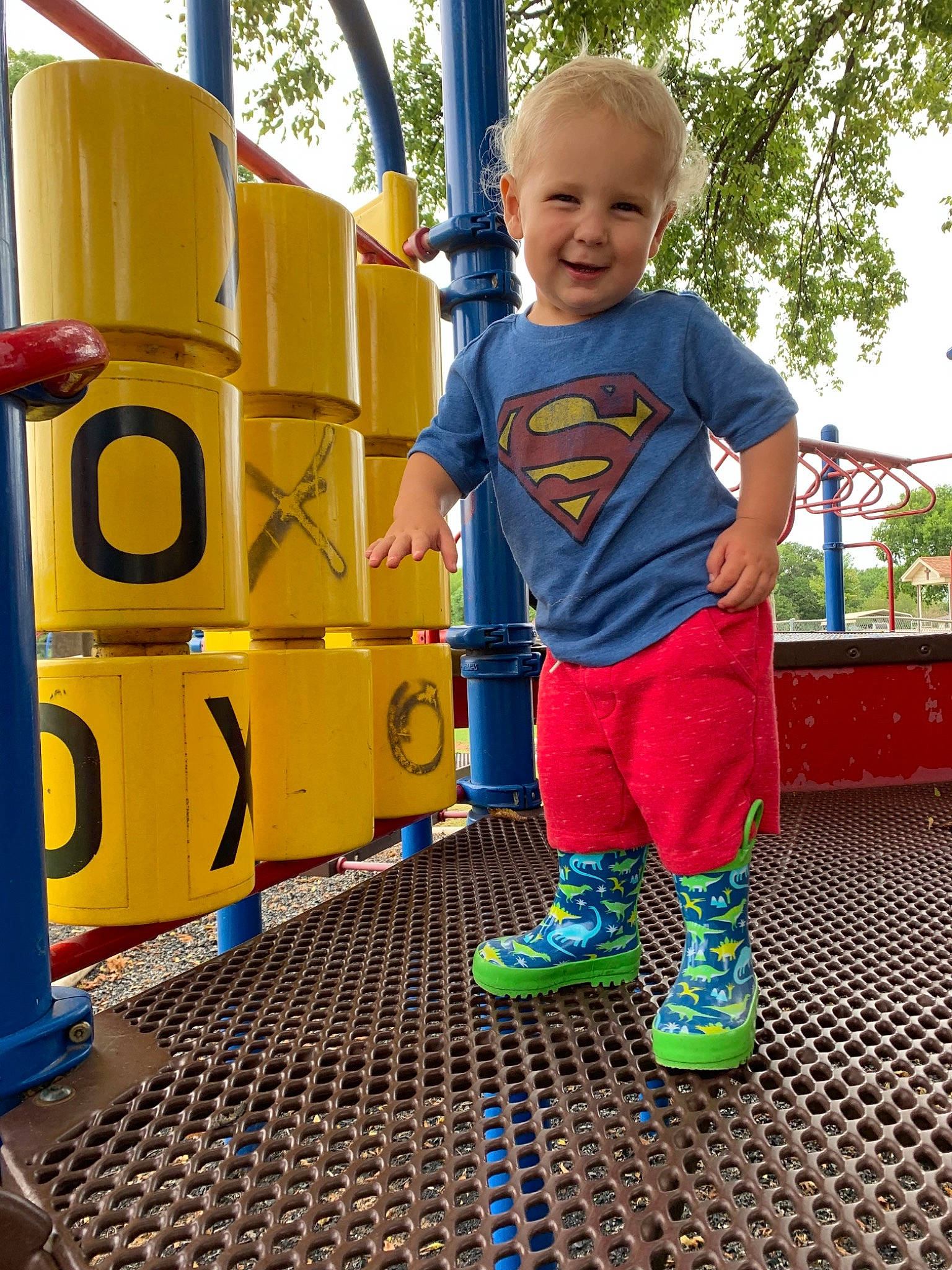 Abram is registered to the contest to win money with this photo: child, city, costume, electric_blue, fictional_character, fun, human_settlement, joy, outdoor_play_equipment, outerwear, person, play, playground, public_space, recreation, smile, t_shirt, toddler, vacation, yellow
