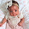 Madisyn is registered to the contest to win money with this photo: baby, infant, child, headband, bow, pink, white, striped_clothing, blanket, soft_texture, cute, portrait, smile, face, eyes, skin, hand, lying_down, indoors, adorable