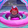 Scarlet joined the competition — help win amazing prizes! baby, child, pool, inflatable, float, pink, hat, floral, water, sunny, outdoor, canopy, summer, swimsuit, smiling, happy, playful, face, cute, relaxing