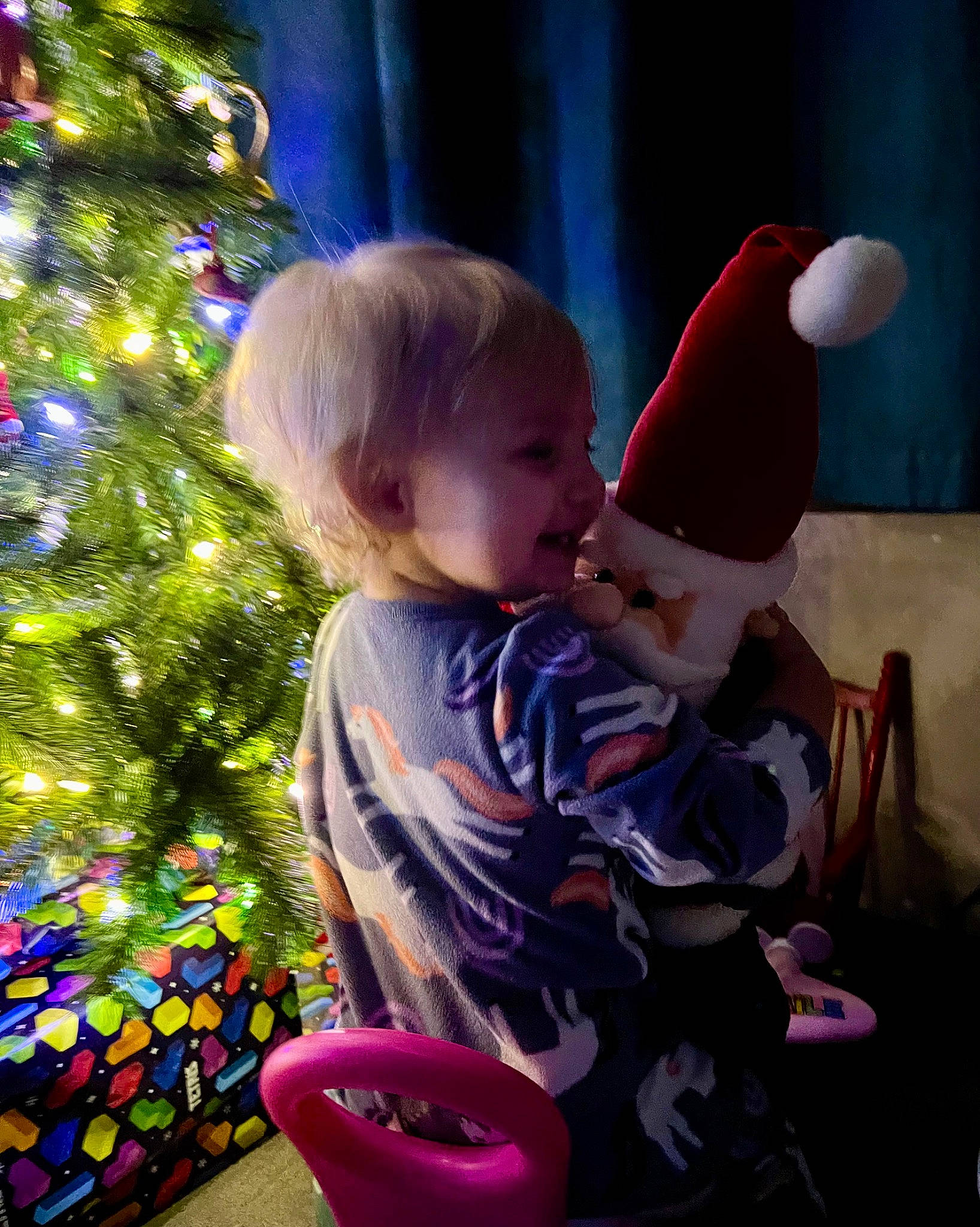 Jaxsyn is registered to the contest to win money with this photo: baby, baby_toddler_clothing, cap, child, christmas, christmas_decoration, christmas_eve, christmas_ornament, christmas_tree, event, fun, happy, hat, holiday, holiday_ornament, human_body, light, person, purple, toddler