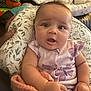 baby, infant, child, cute, face, expression, pillow, blanket, clothing, butterfly, pattern, hand, indoor, soft_toys, couch, person, portrait, curious, wide_eyes, seated