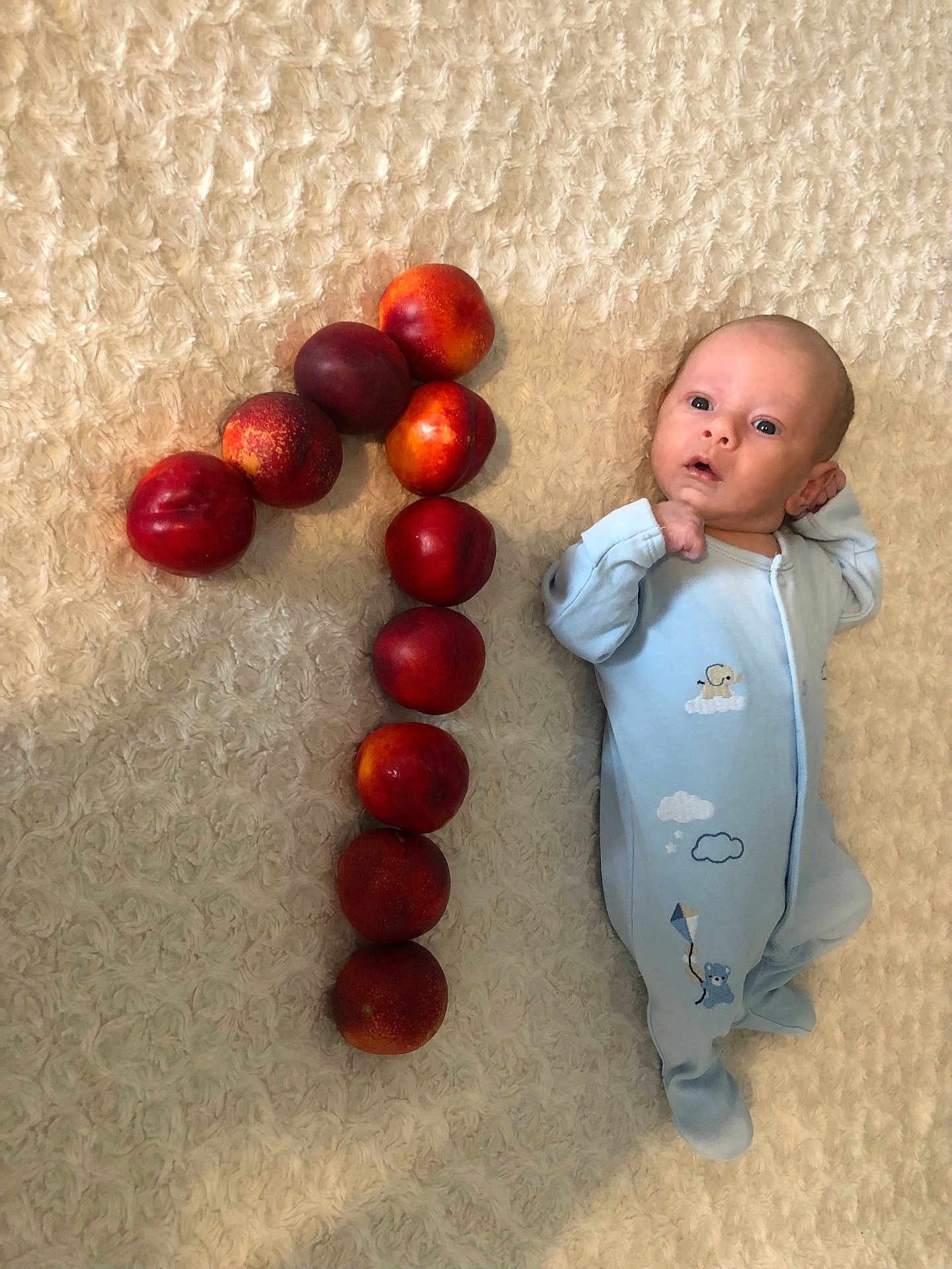 Laurențiu joined the competition — help win amazing prizes! baby, infant, blue_sleeper, nectarines, fruit, number_one, blanket, soft_texture, laying_down, cute, newborn, celebration, fruit_arrangement, pattern, skin, person, young_child, indoors, still_life, sleepwear