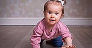 Madalynn joined the competition — help win amazing prizes! toddler, child, baby, crawling, floor, wooden_floor, pink_sweater, blue_jeans, white_bows, hair_ties, indoor, portrait, cute, curious, reaching_hand, person, young_child, face, eyes, smiling