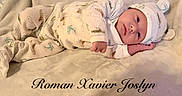 Roman is registered to the contest to win money with this photo: baby, infant, pajamas, hat, blanket, soft_texture, lying_down, cute, face, child, portrait, sleepwear, animal_print, cozy, indoors, newborn, resting, warm, comfortable, name_text
