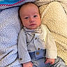 Roman is registered to the contest to win money with this photo: baby, infant, bow_tie, clothing, blanket, fabric, face, person, cute, portrait, blue_pants, buttoned_shirt, hand, lying_down, soft_texture, cozy, indoor, young_child, expression, sleeves