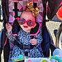 baby, baby_bottle, black, child, cute, gold_bow, happy, infant, leopard_print, outdoor, pattern, pink, play, seatbelt, smiling, stroller, sunglasses, sunlight, toddler, toy