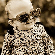 Hope is registered to the contest to win money with this photo: apparel, baby, child, clothing, cute, eyewear, face, fashion, happy, head, heart_shaped, infant, leopard_print, outdoor, person, portrait, smile, stylish, sunglasses, young_child