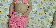 Hope is registered to the contest to win money with this photo: baby, smiling, mermaid_costume, pink, crib, baby_bottle, blanket, patterned_sheet, cute, infant, lying_down, happy, child, clothing, toddler, hand, face, playful, indoors, nursery