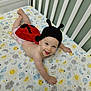 Hope joined the competition — help win amazing prizes! baby, infant, crib, crawling, ladybug_costume, knit_hat, smiling, happy, cute, colorful, sheet, sun, moon, stars, clouds, indoor, child, person, playful, bed