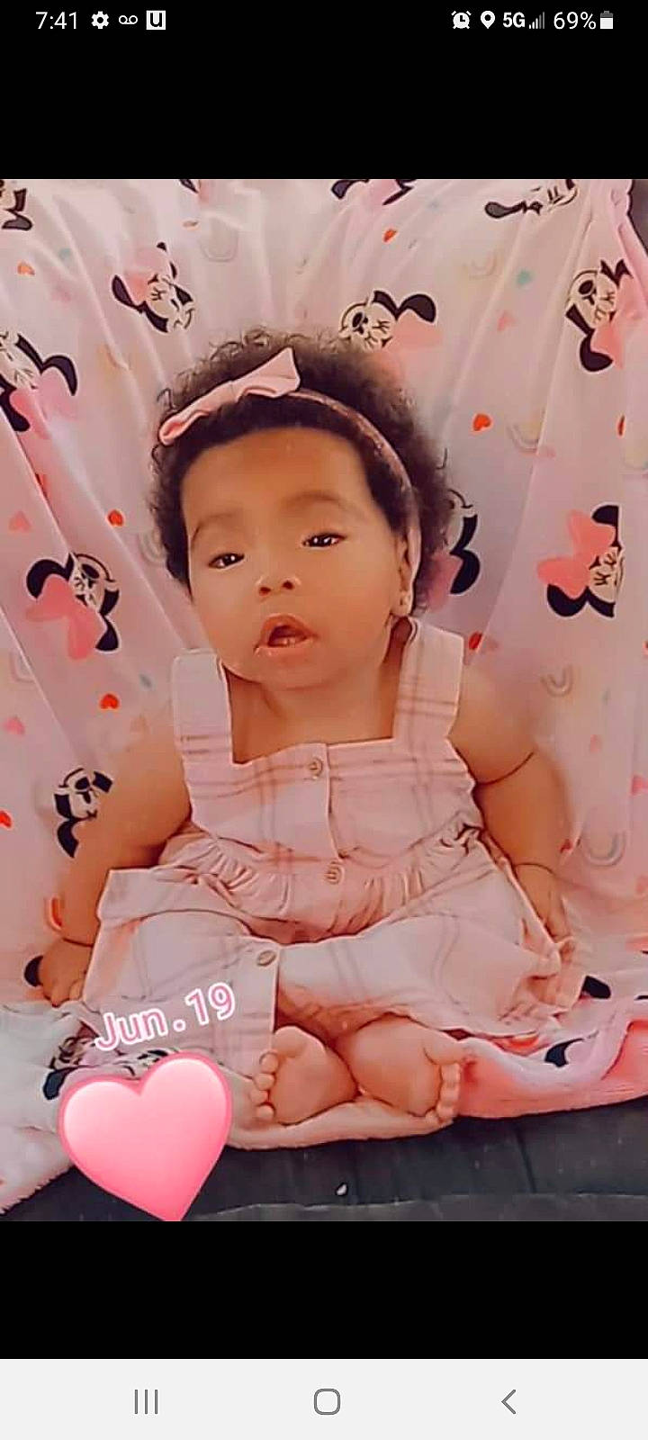 Gisselle is registered to the contest to win money with this photo: baby_toddler_clothing, bangs, cheek, child, facial_expression, fun, gesture, hairstyle, happy, magenta, pattern, peach, people, person, pink, skin, sleeve, sweetness, textile, toddler