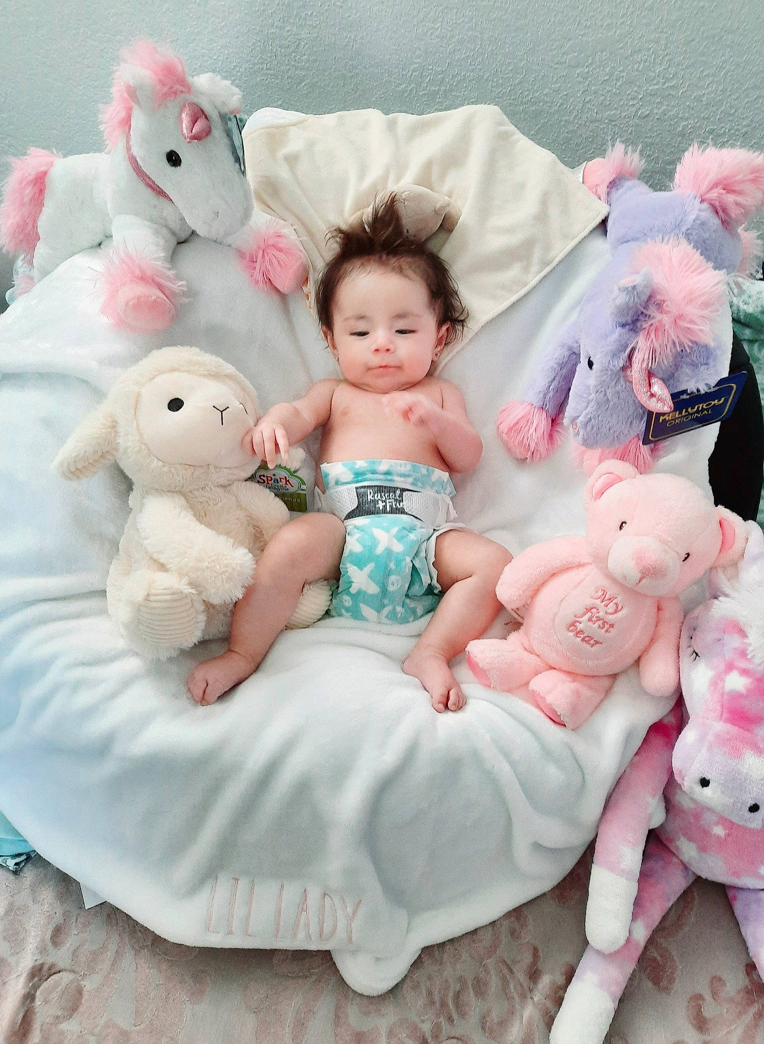 Evyanna is registered to the contest to win money with this photo: baby, baby_toddler_clothing, beauty, child, doll, dress, event, happy, headpiece, linens, person, pink, plush, product, sitting, skin, stuffed_toy, teddy_bear, textile, toddler