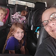 Gabrielle joined the competition — help win amazing prizes! child, adult, car_seat, blanket, glasses, smile, vehicle_interior, seat, hair, person, window, clothing, happy, transportation, family, seatbelt, car, safety, portrait, indoor