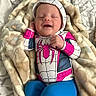 baby, infant, smiling, spiderman_costume, hoodie, blanket, blue_pants, sleeping, cute, child, bed, soft_texture, patterned_blanket, happy, small_hand, cozy, portrait, indoors, resting, young_child