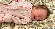 Elliana joined the competition — help win amazing prizes! baby, sleeping, pink_onesie, blanket, floral_pattern, cozy, infant, cute, smile, soft_texture, child, resting, indoors, warm, face, skin, hair, comfort, peaceful, young