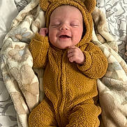 Elliana joined the competition — help win amazing prizes! adorable, baby, bear_costume, blanket, child, costume, cozy, cute, face, fuzzy_clothing, happy, indoors, infant, lying_down, newborn, portrait, sleeping, smiling, soft_texture, warm_clothing