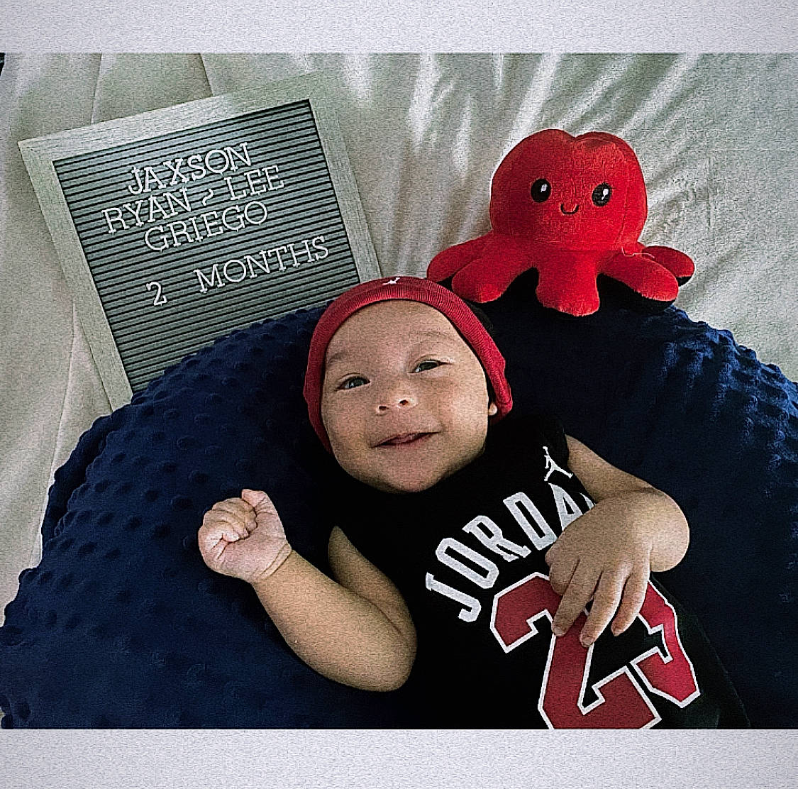 Jaxson is registered to the contest to win money with this photo: art, baby, baby_products, baby_sleeping, baby_toddler_clothing, child, comfort, font, gesture, happy, headwear, illustration, linens, person, product, room, sleeve, smile, t_shirt, textile