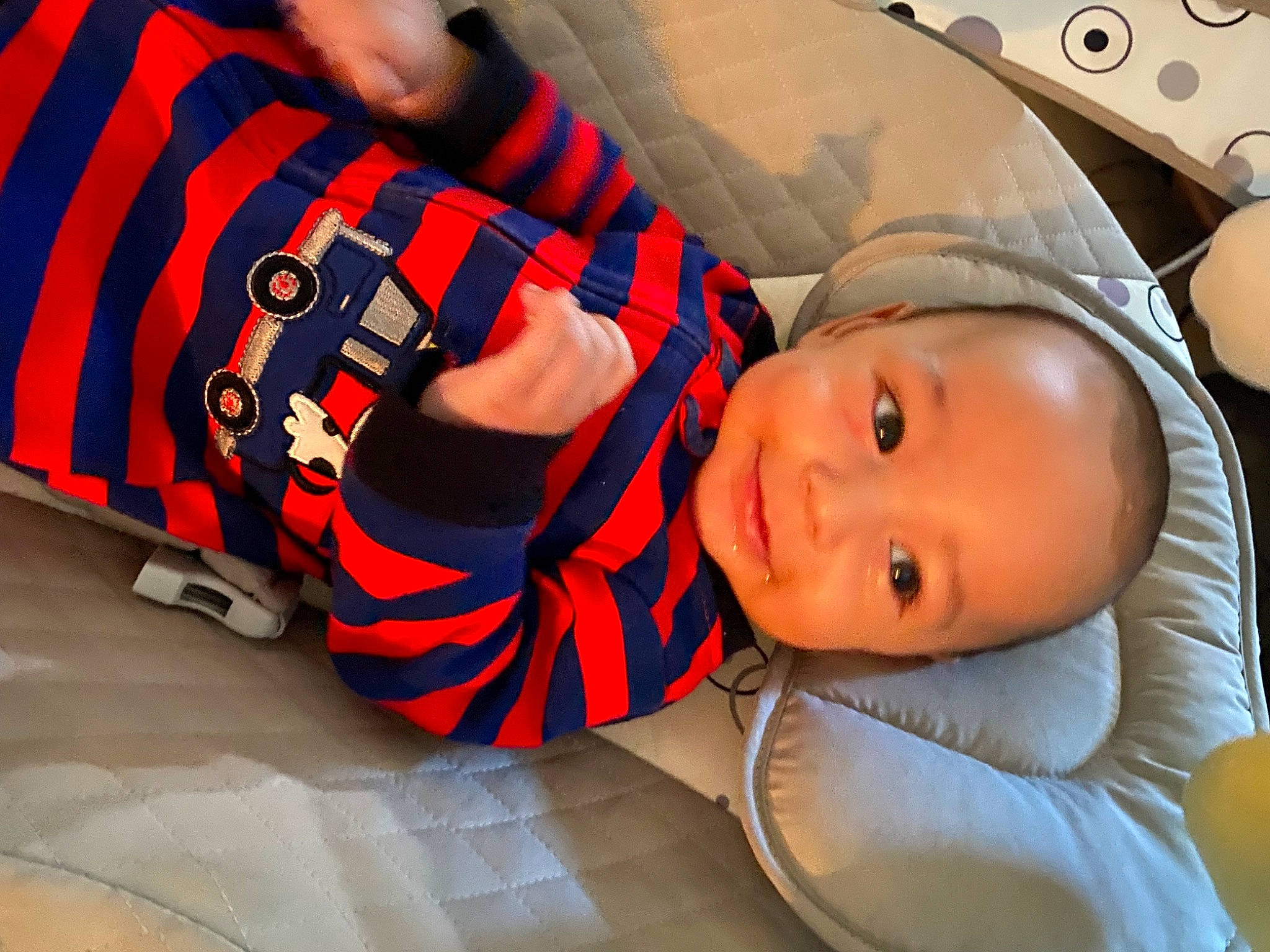 Jaxson is registered to the contest to win money with this photo: arm, baby, baby_products, baby_toddler_clothing, carmine, child, comfort, elbow, facial_expression, fashion_accessory, fun, happy, human_leg, mouth, pattern, person, plaid, sitting, sleeve, smile
