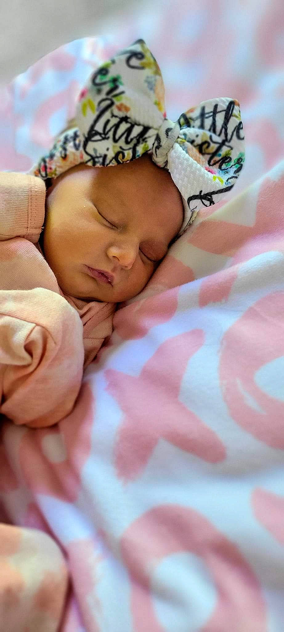Loretta is registered to the contest to win money with this photo: baby, baby_products, baby_sleeping, baby_toddler_clothing, bed, bed_sheet, bedding, bedtime, cap, child, comfort, gesture, happy, headwear, knit_cap, linens, nail, nap, person, pink