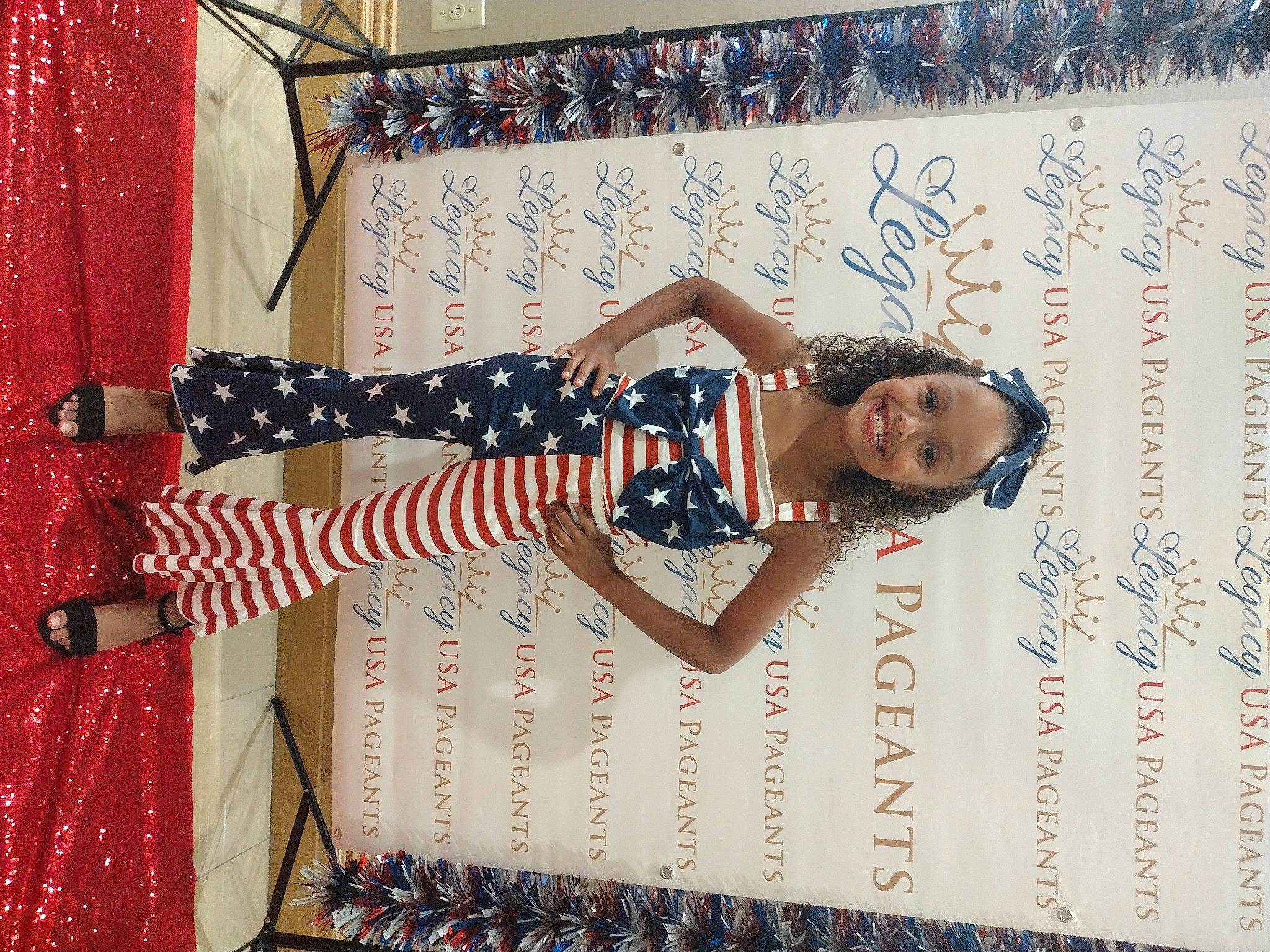 Olivia joined the competition — help win amazing prizes! advertising, curtain, entertainment, event, eyewear, fashion_design, flag, flag_day_usa, flag_of_the_united_states, font, fun, happy, joy, party_supply, pattern, performance, performing_arts, person, red, smile
