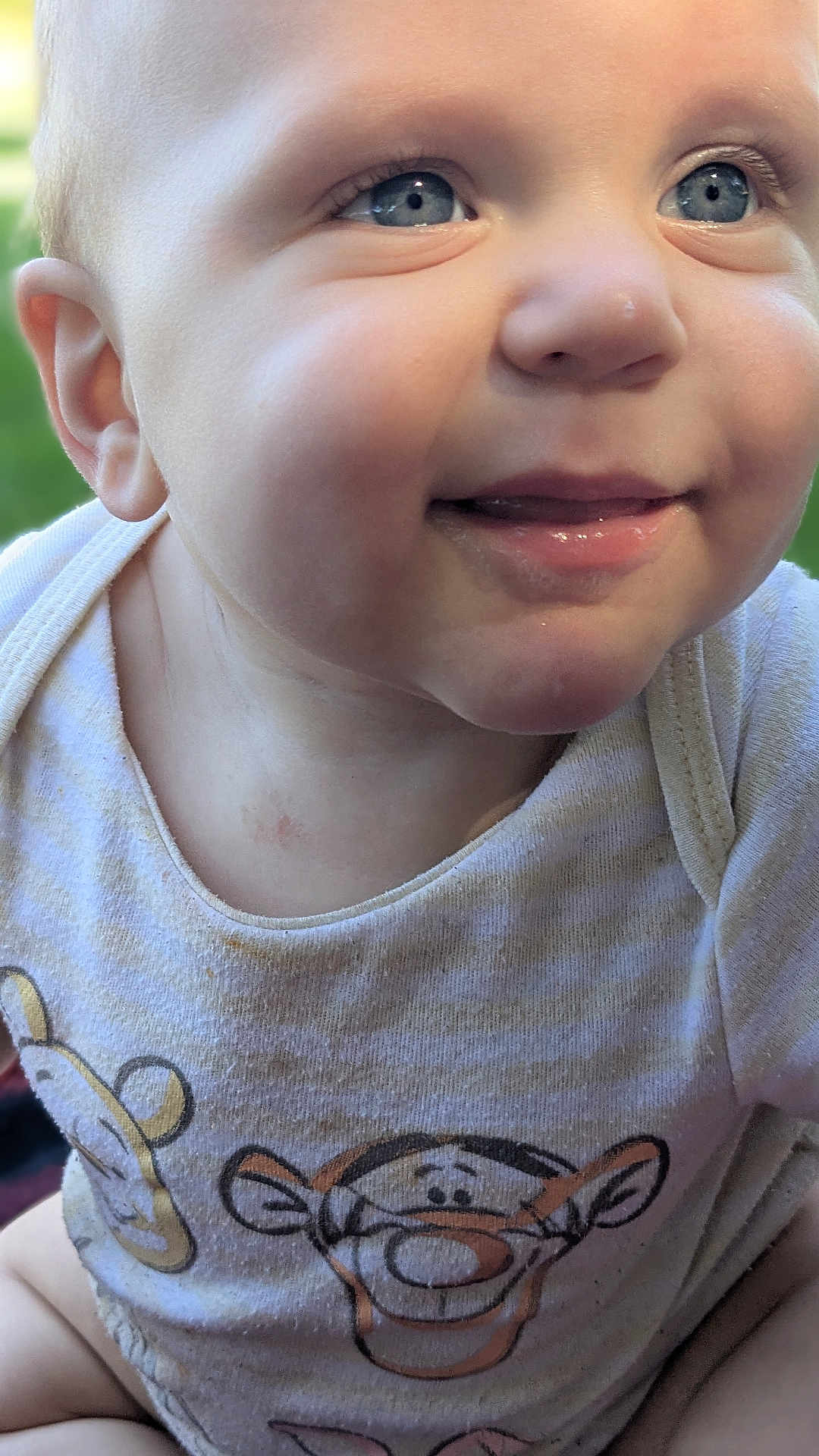 Kekoa is registered to the contest to win money with this photo: baby, child, smiling, face, blue_eyes, close-up, infant, cute, expression, shirt, clothing, cartoon, tiger, striped, skin, natural_light, portrait, happy, young, person