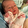 Ivory is registered to the contest to win money with this photo: newborn, baby, infant, person, face, clothing, pink, polka_dots, hand, blanket, sleepy, cute, portrait, indoors, holding, close_up, skin, head, eyes, young_child