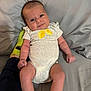 baby, clothing, couch, cute, expression, face, furniture, hand, happy, indoor, infant, leg, lemon_graphic, onesie, person, relaxing, skin, smile, sock, support