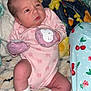 Ivory joined the competition — help win amazing prizes! baby, infant, pink_clothing, mittens, white_socks, blanket, patterned_blanket, face, person, newborn, sleepwear, cute, indoors, resting, soft_texture, child, young, cozy, pajamas, colorful