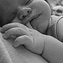 baby, sleeping, hand, closeup, black_and_white, infant, face, peaceful, soft, skin, portrait, cute, child, newborn, resting, expression, calm, fingers, monochrome, tender