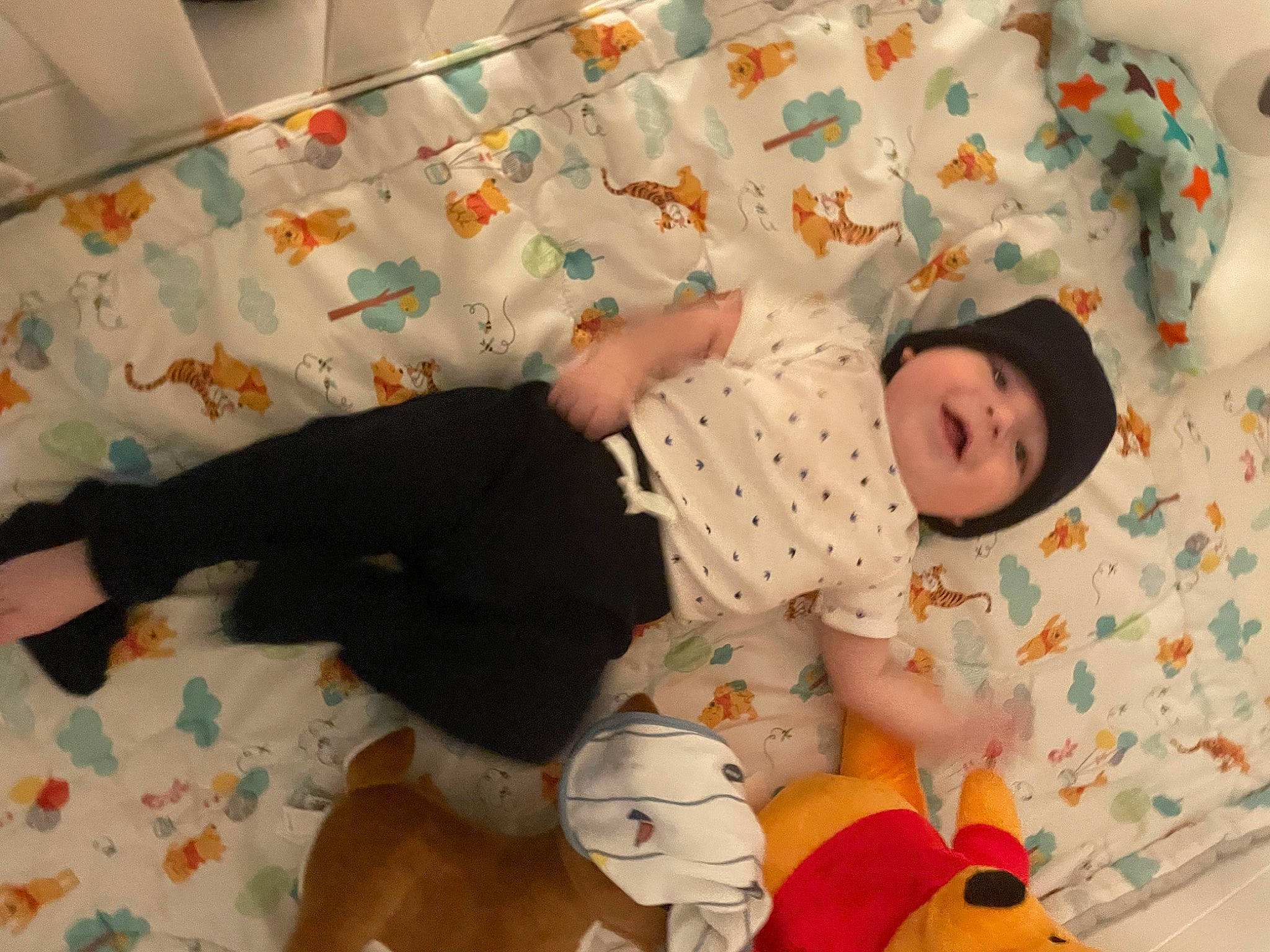 Easton is registered to the contest to win money with this photo: baby, baby_products, baby_safety, baby_toddler_clothing, baby_toys, child, comfort, flooring, foot, fun, head, headwear, human_body, linens, pattern, person, play, room, sitting, sock