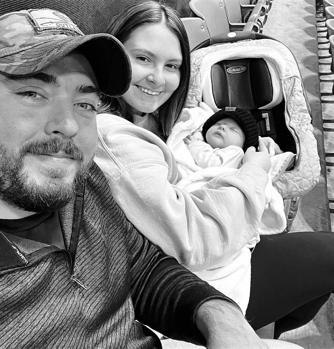 Juliana is registered to the contest to win money with this photo: automotive_design, baseball_cap, beard, black, black_and_white, cap, cool, eyewear, face, facial_expression, fun, happy, headgear, interaction, joy, monochrome, motor_vehicle, person, photograph, smile