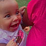 baby, child, smile, happy, face, hand, pink_clothing, outdoor, grass, person, toddler, cute, joy, holding, portrait, young_child, bright_colors, expression, closeup, infant