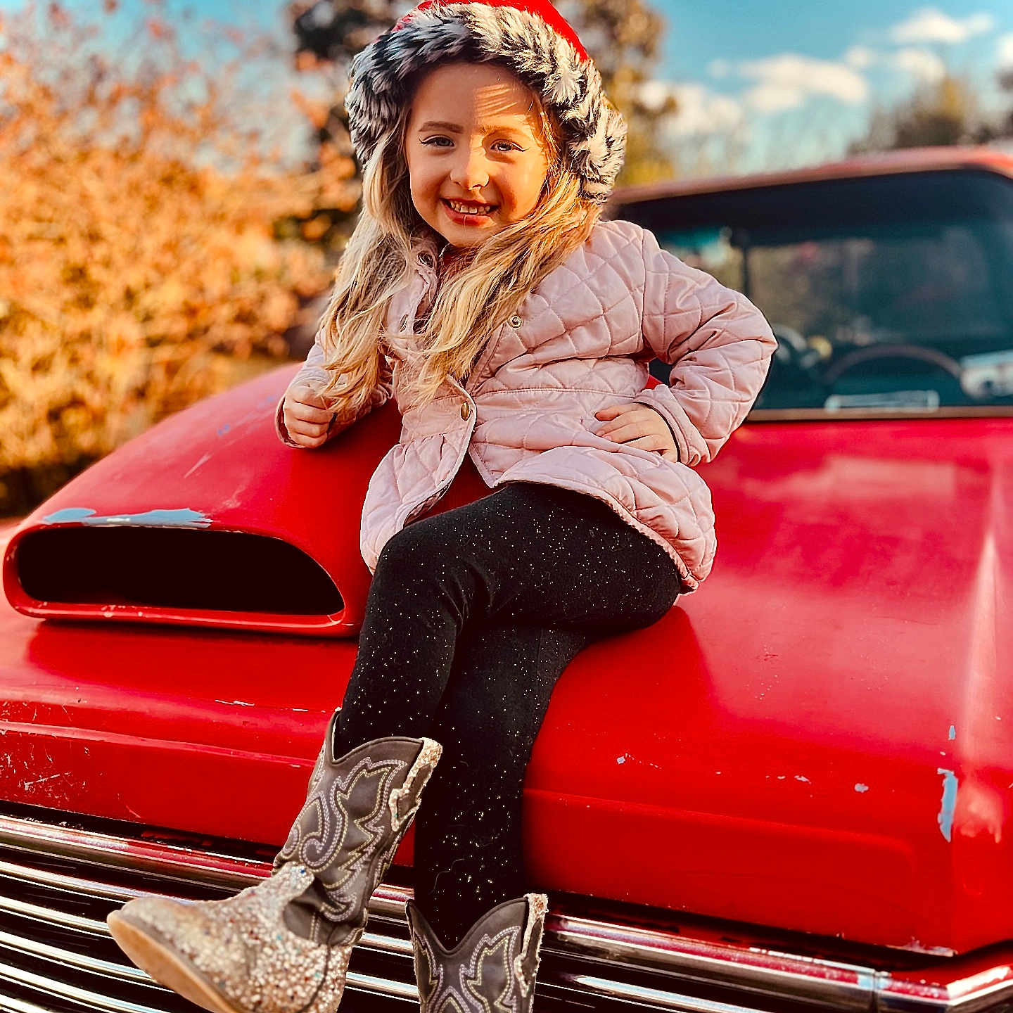Ella joined the competition — help win amazing prizes! adult, boot, car, clothing, face, female, footwear, happy, hat, head, pants, person, photography, portrait, shoe, sitting, smile, transportation, vehicle, woman