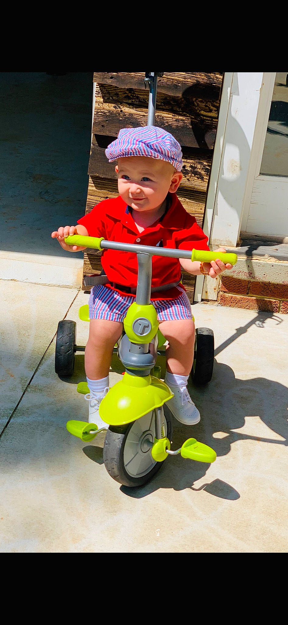 Love Bug is registered to the contest to win money with this photo: child, fun, headwear, person, play, riding_toy, toddler, tricycle, vehicle, wheel