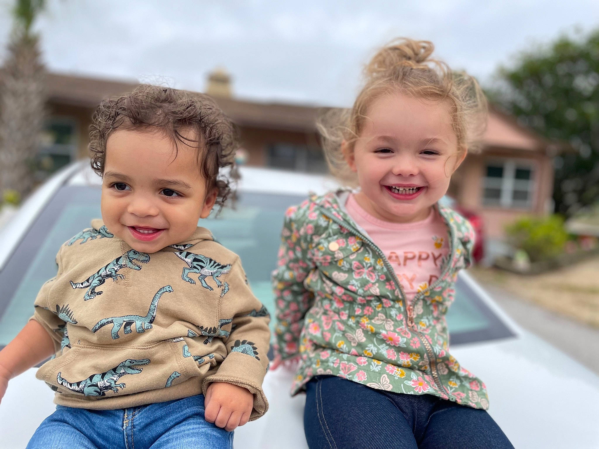 Mia joined the competition — help win amazing prizes! baby, baby_toddler_clothing, blond, child, event, fun, gesture, grass, happy, iris, jeans, joy, leisure, person, plant, sitting, skin, sleeve, smile, t_shirt