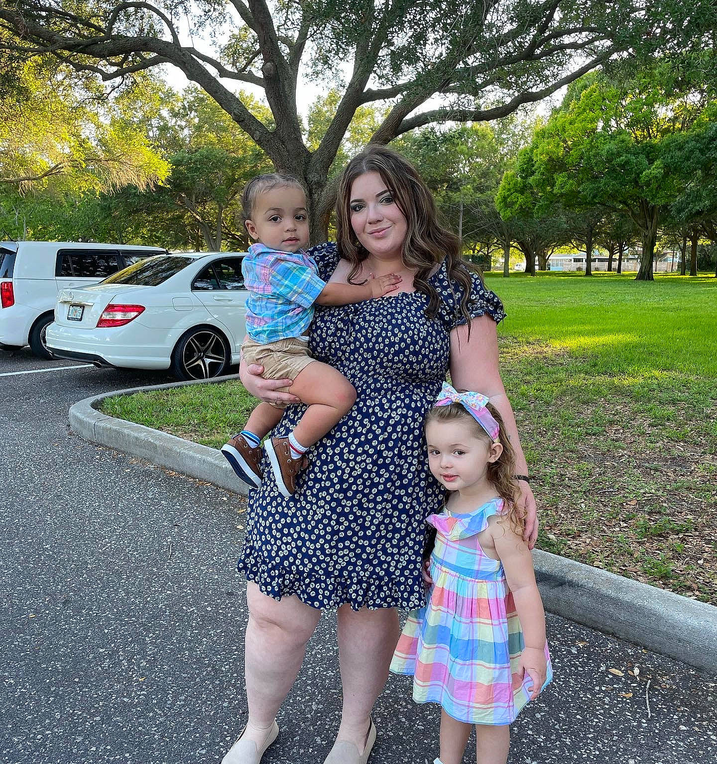 Mia joined the competition — help win amazing prizes! car, day_dress, dress, fashion, gesture, grass, happy, joy, leisure, people, person, photograph, plant, smile, summer, tire, toddler, tree, vehicle, waist