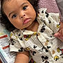 baby, infant, child, mickey_mouse, shirt, clothing, blanket, baby_seat, soft_texture, curly_hair, cute, hand, face, eyes, indoor, comfort, portrait, expression, young_child, baby_girl