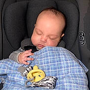 Aveyin joined the competition — help win amazing prizes! baby, infant, sleeping, car_seat, blanket, pacifier, hand, face, head, harness, safety_label, newborn, plaid_blanket, blue_blanket, gray_seat, closeup, indoor, soft_lighting, peaceful, binky