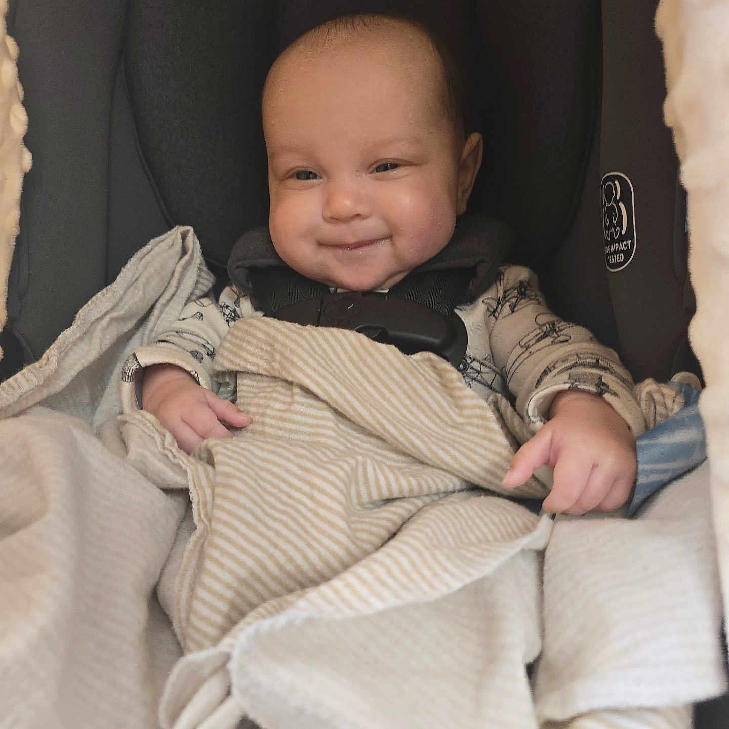 Aveyin is registered to the contest to win money with this photo: baby, blanket, buckle, car_seat, cheeks, cozy, cute, fabric, hands, harness, headrest, human, indoor, infant, pajamas, portrait, safety_label, seat, smile, soft_lighting