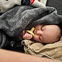 Aveyin is registered to the contest to win money with this photo: baby, infant, newborn, sleeping, pacifier, blanket, grey_blanket, cozy, peaceful, hand, face, closed_eyes, forehead, cheek, swaddle, pillow, couch, soft_texture, serene, nap