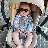 Léandre participe au concours pour gagner de l'argent avec cette photo : baby, sunglasses, car_seat, stroller, child, cobblestone, outdoor, feet, legs, hands, clothing, straps, safety, cute, sunny, head_support, toy, fashion, infant, relaxing