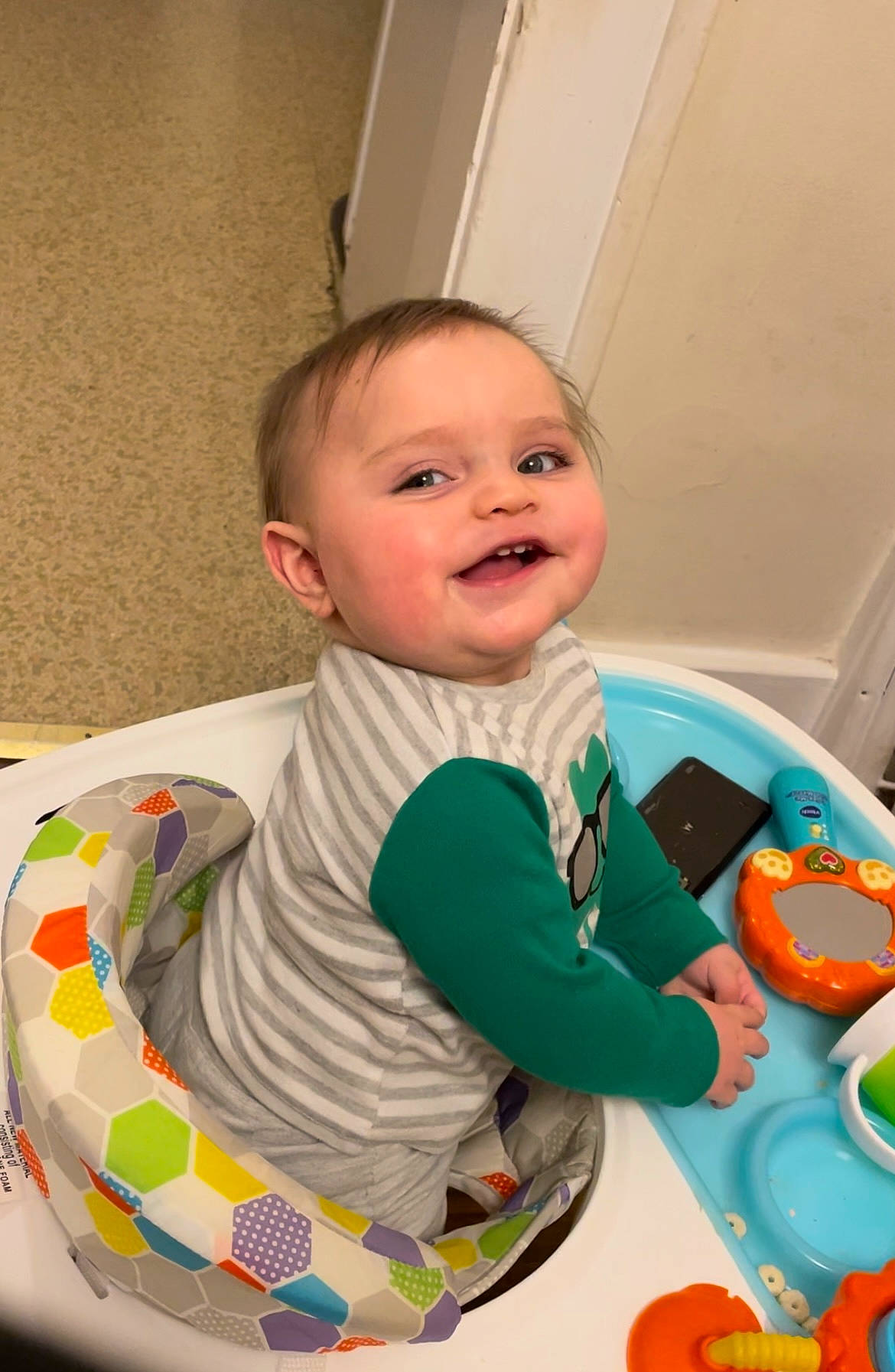 Issac is registered to the contest to win money with this photo: baby, baby_playing_with_toys, baby_products, baby_toddler_clothing, chair, child, comfort, eye, facial_expression, flooring, fun, green, happy, joy, leisure, person, play, product, room, sitting