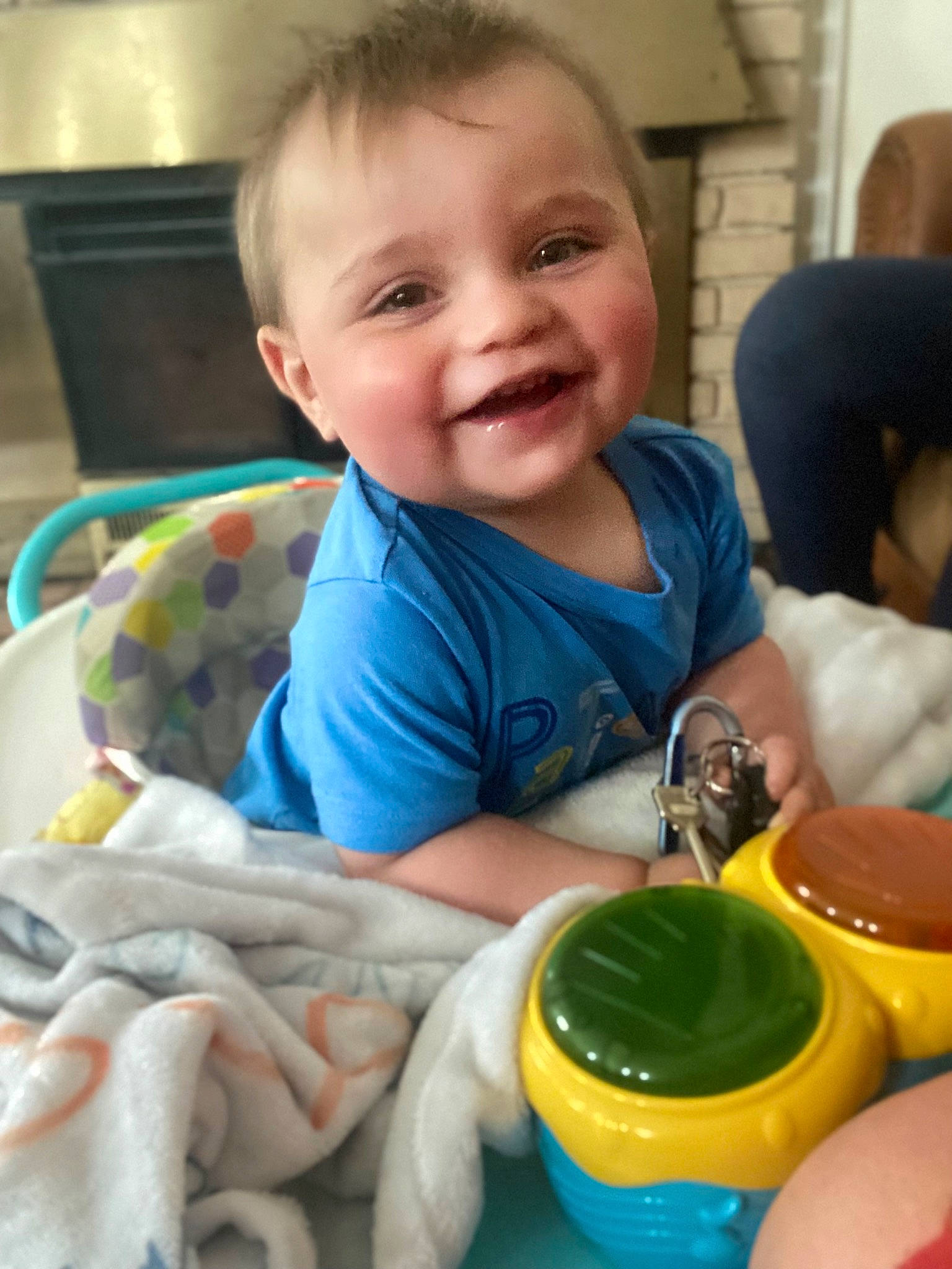 Issac is registered to the contest to win money with this photo: baby, baby_toddler_clothing, chair, cheek, child, comfort, drinkware, face, fun, happy, joy, person, plastic, plastic_bottle, play, product, room, sitting, skin, smile