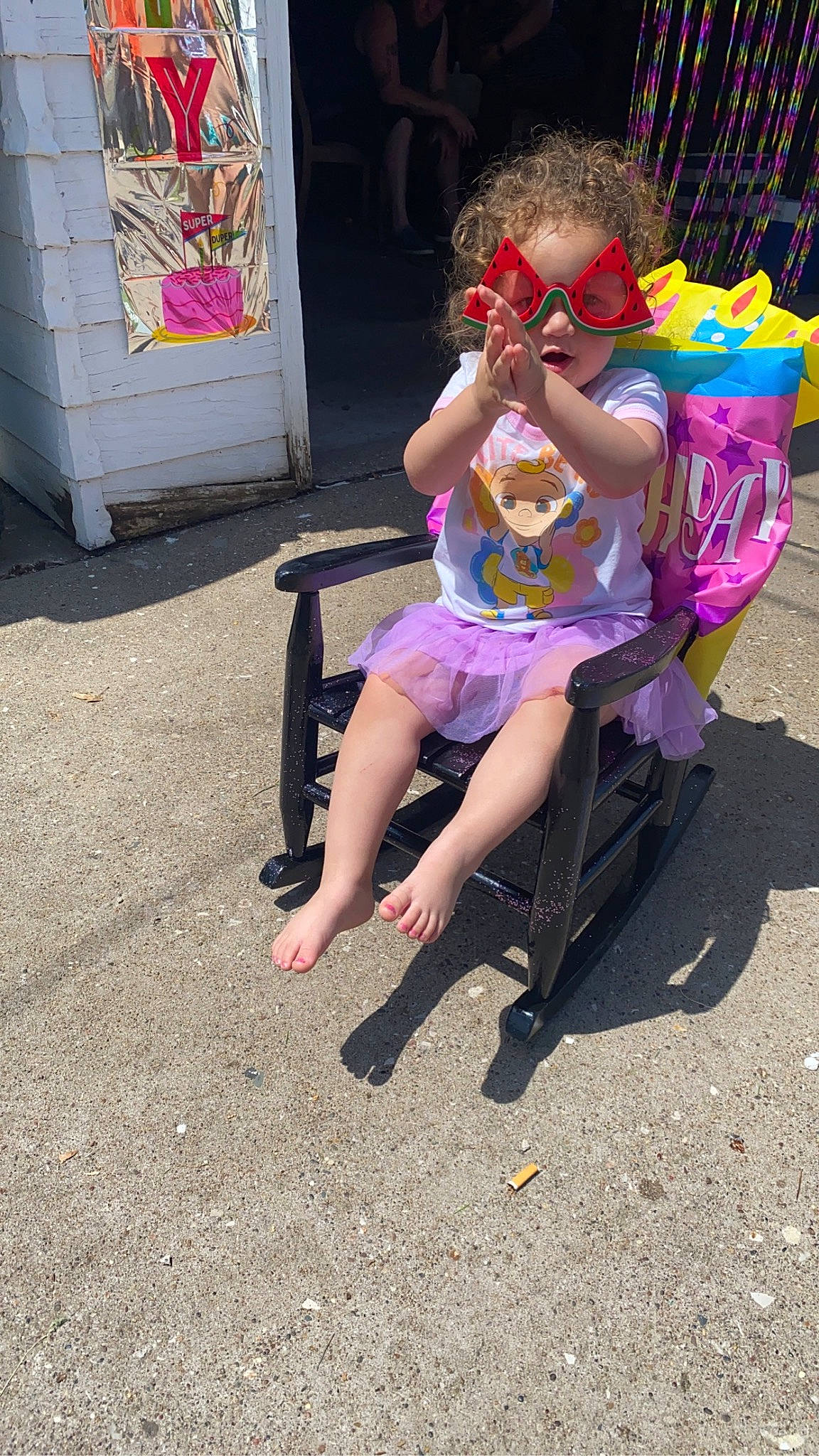 Nylie joined the competition — help win amazing prizes! barefoot, calf, city, event, eyewear, flip_flops, foot, fun, human_leg, leisure, magenta, person, play, recreation, sandal, sidewalk, sitting, street, sunglasses, thigh