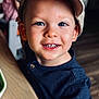 Alex joined the competition — help win amazing prizes! child, boy, smile, cap, blue_eyes, indoor, table, hand, face, clothing, casual_wear, person, portrait, happy, young, cute, skin, headwear, wood, background_blur