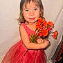 celebration, child, cute, dress, earrings, eyeglasses_absent, flower, girl, happy, holding, indoor, orange_flowers, person, pink_dress, portrait, posing, short_hair, smile, tulle, young_child