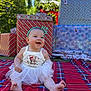 baby, child, tutu, headband, crown, smiling, happy, sitting, blanket, plaid, gift, present, christmas, outdoor, greenery, sunlight, holiday, festive, cute, portrait